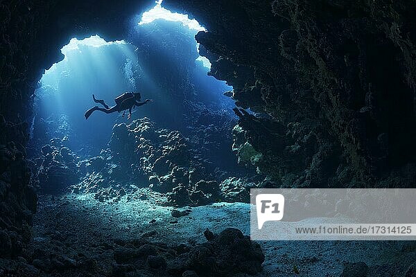 Sonnenstrahlen scheinen durch Riffdach in Höhle im Korallenriff mit Taucher  Shaab Claude  Rotes Meer  Fury Shoals  Ägypen