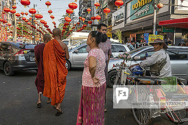 Buddhist monks on busy street in downtown Yangon