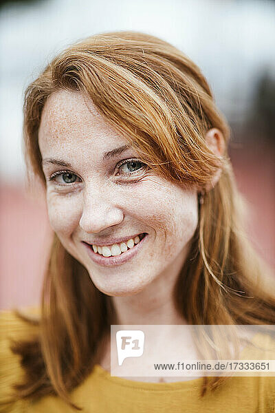 Smiling redhead woman with freckles
