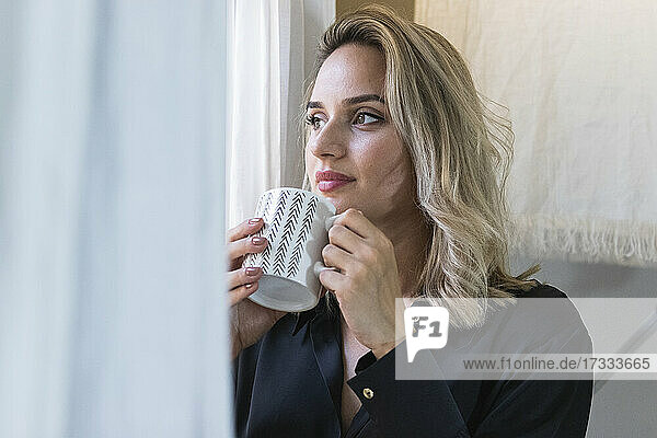 Businesswoman having coffee at home