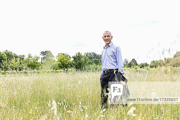 Male professional standing in field