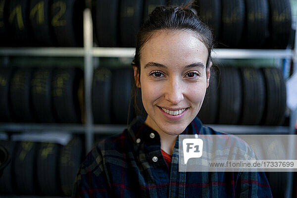 Smiling female mechanic at repair shop