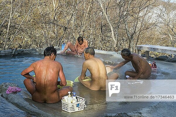 Men sitting in a hot water pool  Unesco world heritage site Shiretoko National Park  Hokkaido  Japan  Asia
