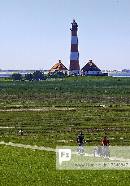 Westerhever Lighthouse with cycling  Eiderstedt  Wadden Sea National Park  North Sea  North Frisia  Schleswig-Holstein  Germany  Europe