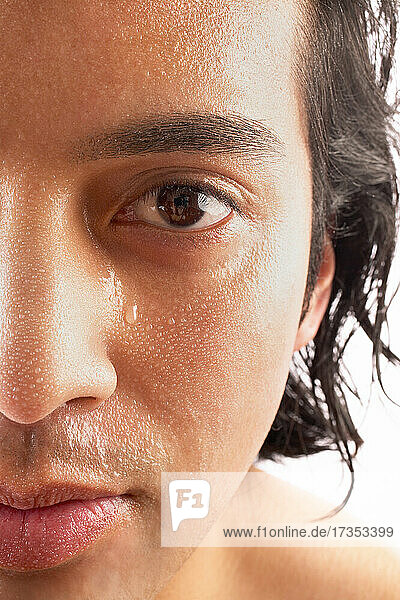 Close-up of man with water drops on face