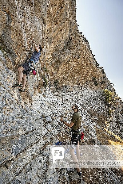 Climbing a rock face  belaying  lead climbing  sport climbing  Kalymnos  Dodecanese  Greece  Europe