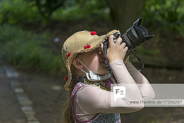 Little girl  8 years  taking pictures  Bavaria  Germany  Europe