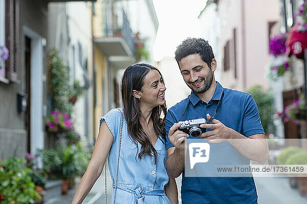 Boyfriend showing camera to smiling girlfriend