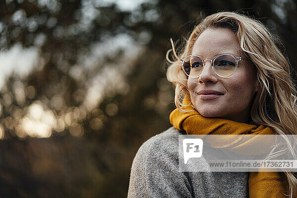 Beautiful woman wearing eyeglasses at sunset