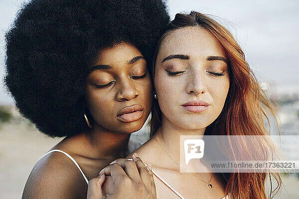 Young lesbian couple with eyes closed