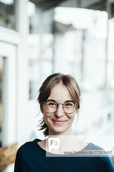 Smiling woman with brown hair wearing eyeglasses