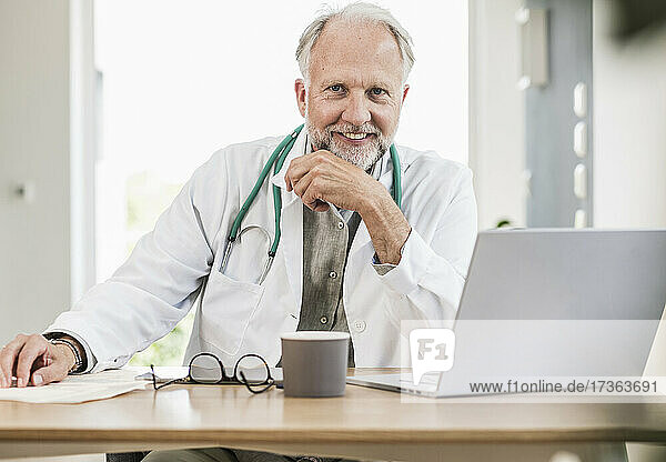 Smiling male medical professional at desk