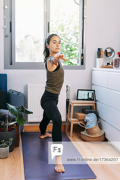 Confident woman exercising at home