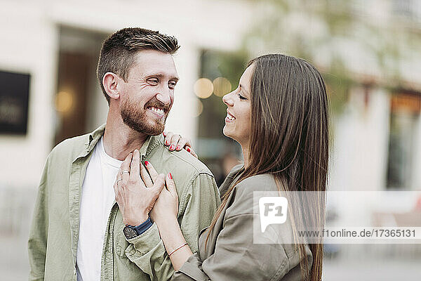 Mid adult man smiling while looking at girlfriend