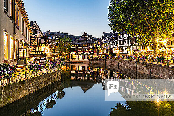Frankreich  Bas-Rhin  Straßburg  Langzeitbelichtung von Fachwerkhäusern  die sich im Flusskanal Petite France Ill in der Abenddämmerung spiegeln