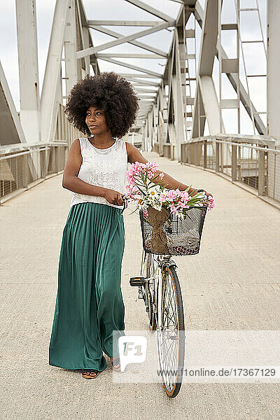 Frau mit Fahrrad zu Fuß auf Brücke