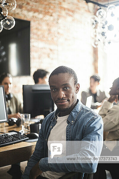 Portrait of male hacker sitting in startup company