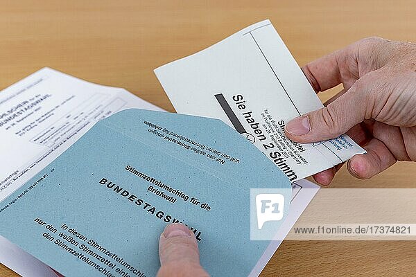 Man puts his folded ballot paper into the ballot paper envelope for the election of members of the German Bundestag on 26.09.2021  Germany  Europe