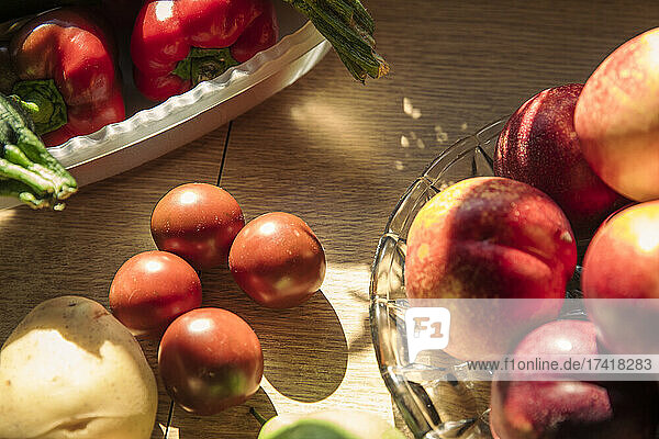 Fresh fruits and vegetables on table at kitchen