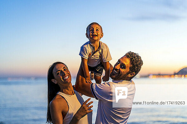 Happy couple with son enjoying at beach