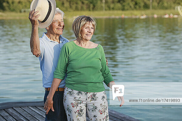 Smiling senior couple standing together on jetty