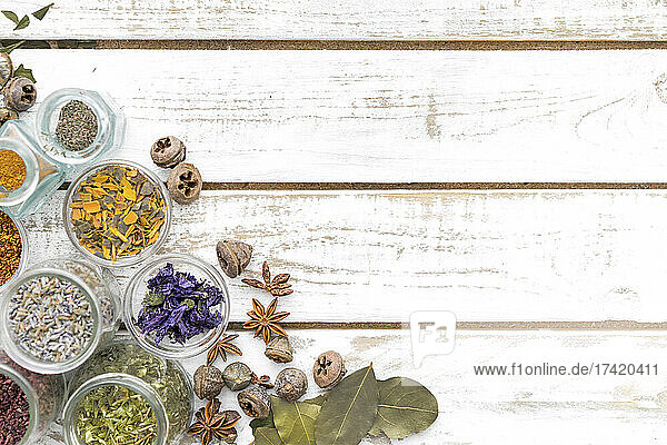 Spices and herbs in bowl on white table