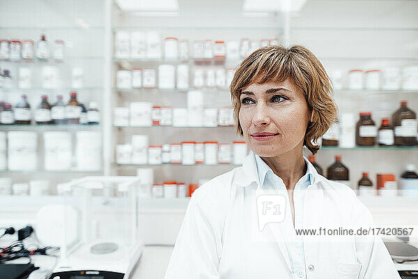 Thoughtful female pharmacist at medical store