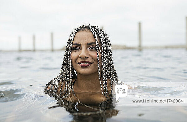Smiling woman enjoying in water during weekend