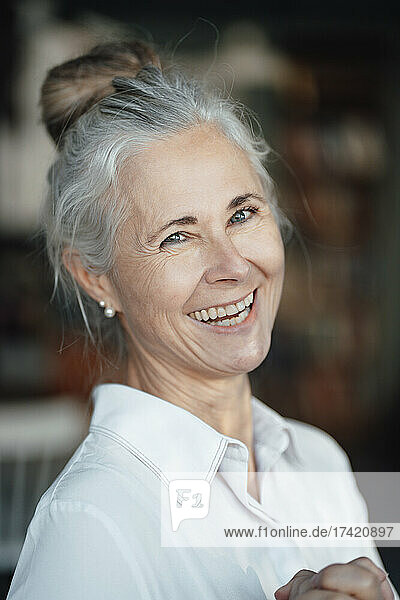 Happy mature woman in coffee shop