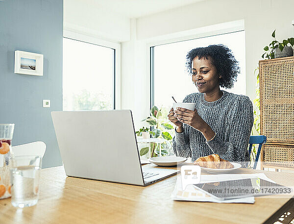 Female professional having coffee at home office