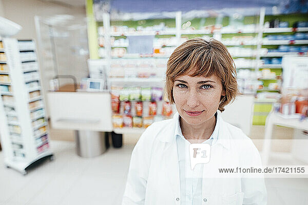 Smiling female professional at pharmacy