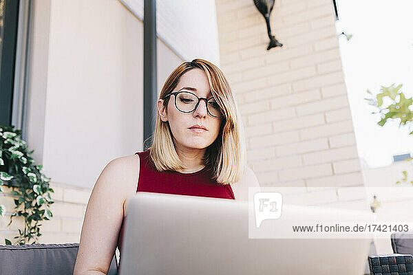 Businesswoman using laptop while working at rooftop