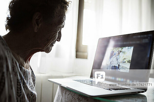 Senior woman watching video at home