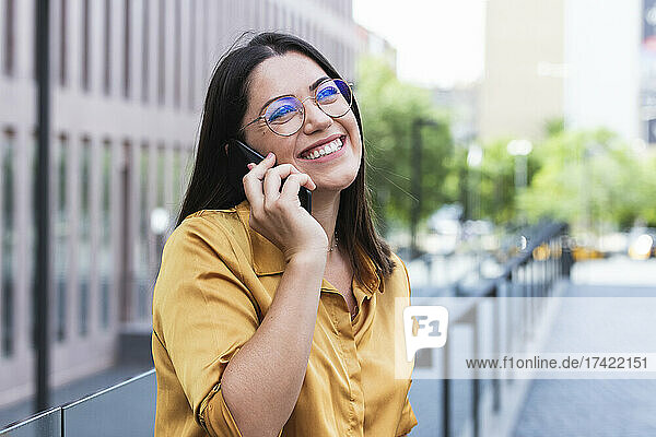 Happy businesswoman talking on smart phone