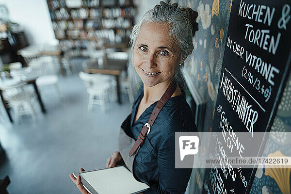 Female entrepreneur with digital tablet in coffee shop