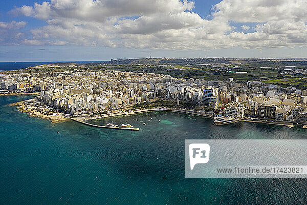 Malta  Northern Region  Saint Pauls Bay  Aerial view clouds over coastal town