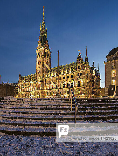 Germany  Hamburg  Snow-covered steps in front of illuminated Hamburg City Hall at dusk