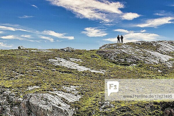Walkers on rocky coast  looking into the distance  Rispond Bay  Durness  Sutherland  Scotland  Great Britain