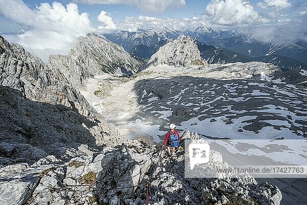 Hiker on the via ferrata to the Patenkirchner Dreitorspitze  Wetterstein Mountains  Garmisch-Partenkirchen  Bavaria  Germany  Europe