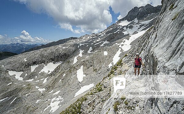 Hiker on a rock face  via ferrata to the Patenkirchner Dreitorspitze  Wetterstein Mountains  Garmisch-Partenkirchen  Bavaria  Germany  Europe