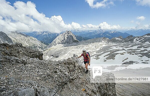 Hiker on the via ferrata to the Patenkirchner Dreitorspitze  Wetterstein Mountains  Garmisch-Partenkirchen  Bavaria  Germany  Europe