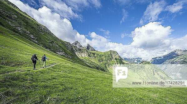 Two hikers on a hiking trail  mountains behind  Heilbronner Weg  Allgäu Alps  Oberstdorf  Bavaria  Germany  Europe