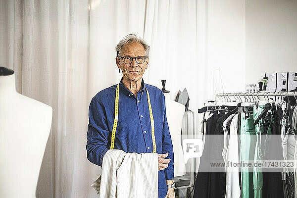 Portrait of male entrepreneur in clothing store