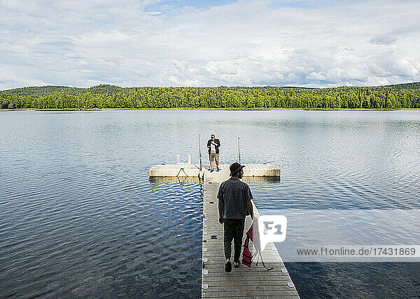 USA  Alaska  Two men on pier on lake in Kenai Fjords National Park