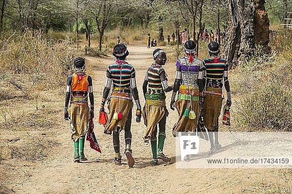 Traditional dressed young girls from the Laarim tribe from behind  Boya hills  Eastern Equatoria  South Sudan  Africa