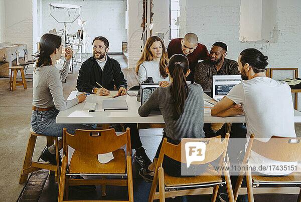Computer programmers discussing in meeting at startup company
