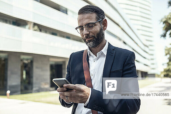 Businessman with eyeglasses using smart phone