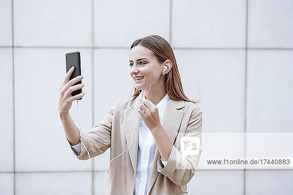 Female business professional attending video call through smart phone