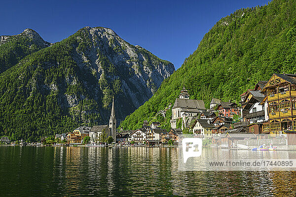 Scenic view of lake by Hallstatt town against clear sky