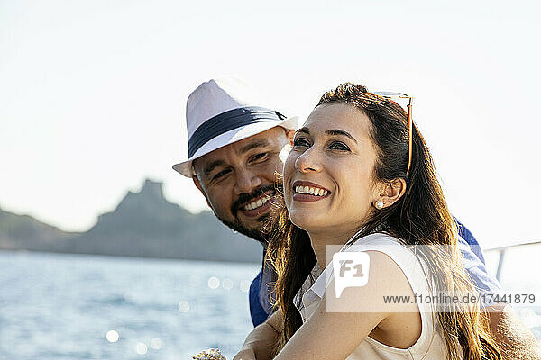 Man with hat looking at happy woman